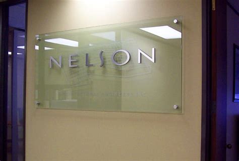 Glass Signage With Brushed Aluminum Letters And Etched 3d Design For