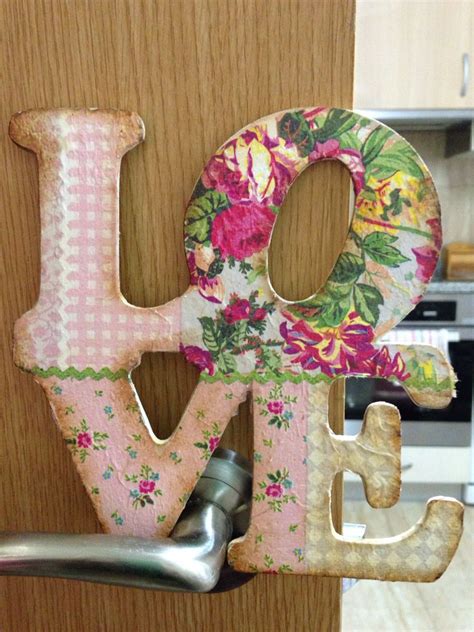 The Letters Are Made Out Of Wood And Have Flowers On Them As Well As