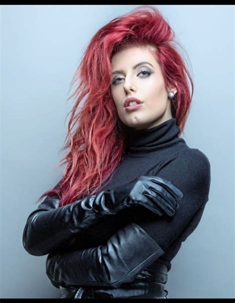 A Woman With Red Hair Wearing Black Leather Gloves