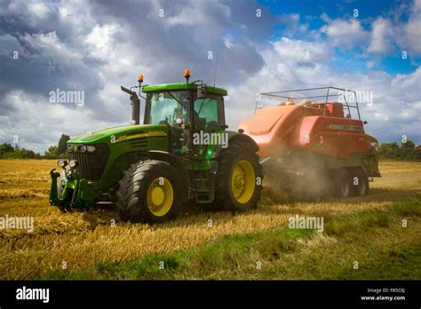 John Deere Tractor And Massey Ferguson Baler Baling Straw Bales Stock