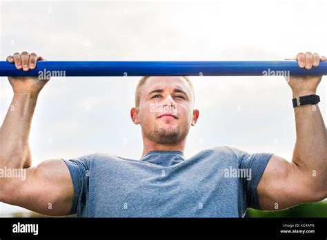 Masculine Man Doing Pull Ups On Street Workout Outdoors Stock Photo Alamy