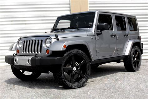 Silver jeep wrangler with black rims