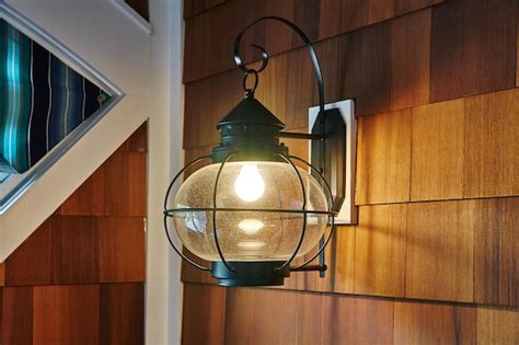 Premium Photo Traditional Lantern Light Fixture On Wooden Siding At Dusk