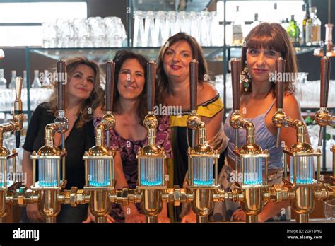 Group Of Mature Women Is Drinking Beer In A Pub In Front Of A Beer Tap Focus On The Tap Stock