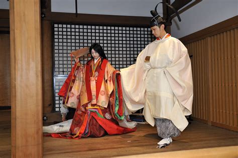 A Man And Woman Dressed In Heian Robes