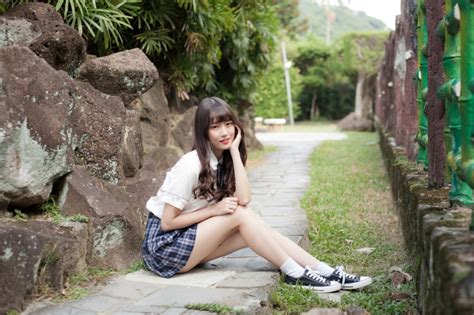 Asian Grass Bokeh Brunette Girl Side Sitting Hands Skirt Legs