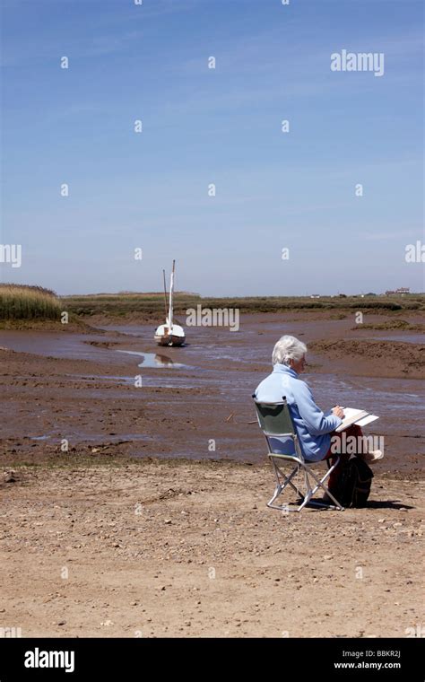 An Artist At Work On The Quayside Of Brancaster Staithe In North