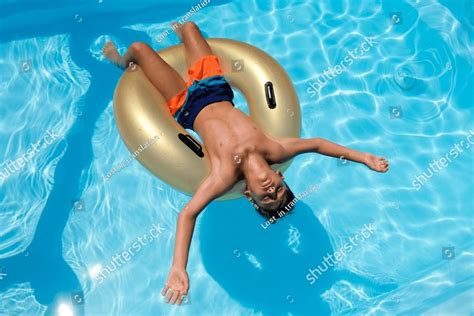 A Boy Going Through A Heat Wave In The Pool Enjoying Summer Vacations