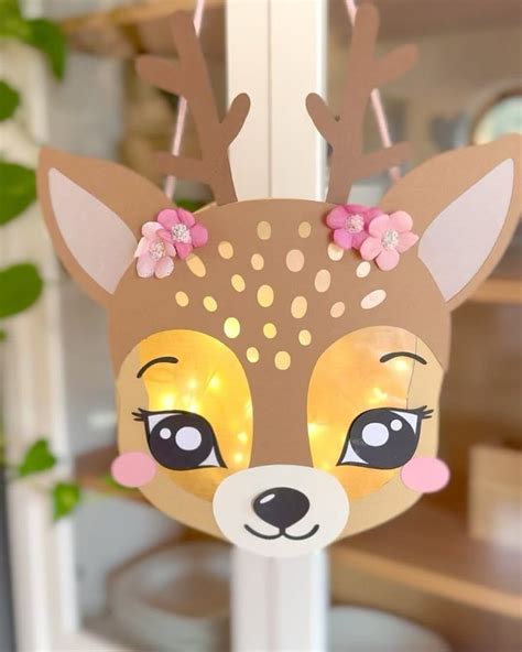 A Paper Deer Head Hanging From A Window