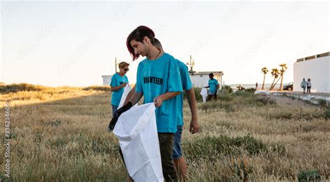 Volunteer beach clean up Stock Photo | Adobe Stock