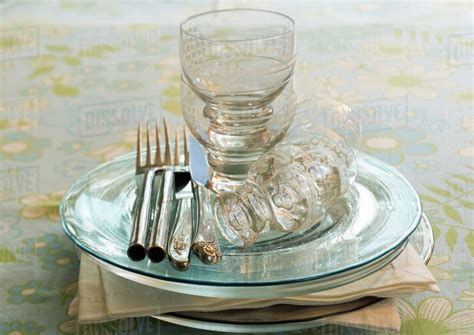 Stack of clean plates, napkins, silverware and glasses - Stock Photo ...