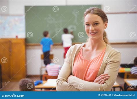 Pretty Teacher Smiling At Camera At Back Of Classroom Stock Image Image Of Development