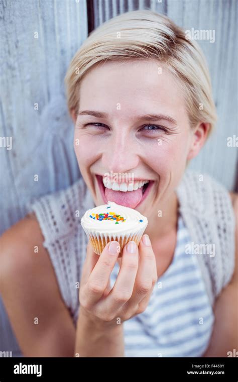 Pretty Blonde Woman Tasting The Cupcake Stock Photo Alamy