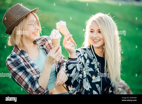 Two Woman Holding Melting Ice Cream Waffle Cone In Hands On Summer