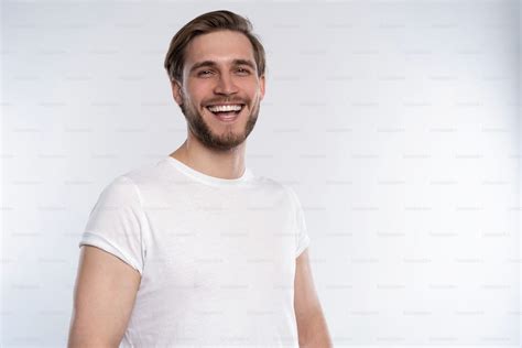 Sexy Smiling Handsome Man In White T Shirt Isolated On White Photo