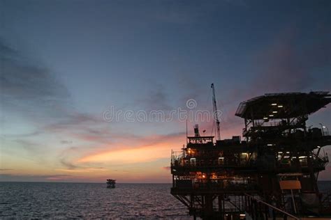 Offshore oil rig at sunset editorial stock photo. Image of pipe - 261279938