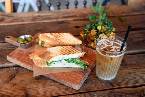 Chicken Sandwich With Iced Coffee On The Table In Cafe Stock Photo