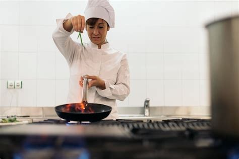 Premium Photo Female Chef Preparing Food In Commercial Kitchen