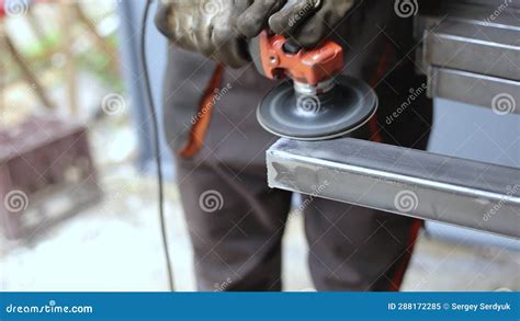 Worker Sanding Welding Seam Iron Steel Pipe Profile Using Angle Grinder Sand Disc Industry