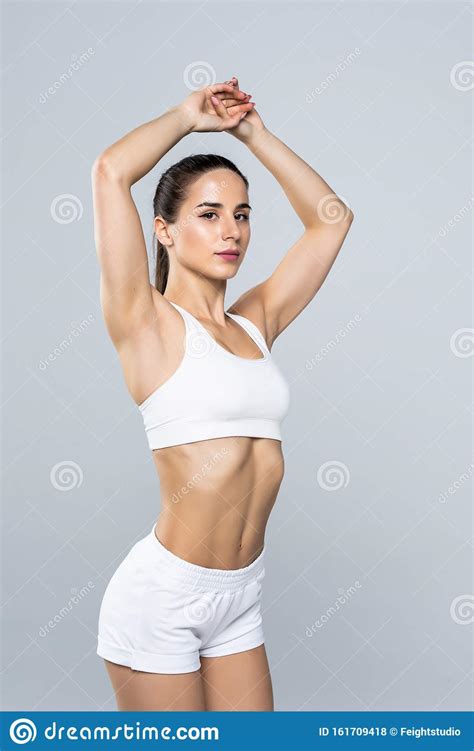 Portrait Of A Fitness Cute Woman Stretching Hands Isolated On A White