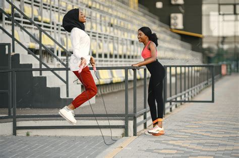 Two black women doing workout on a stadium Stock Photo by prostooleh