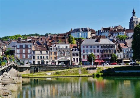 There Are Many Buildings On The Side Of This River That Is Next To A Bridge