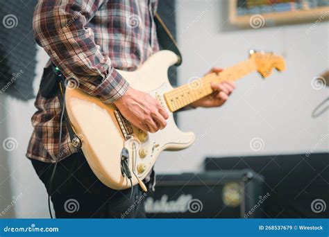 Man Playing An Electric Guitar In Front Of An Amplifier Stock Image