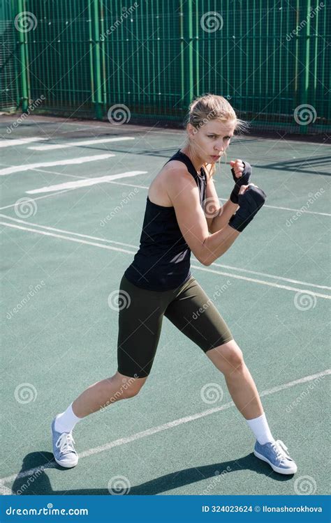 Young Female Boxer Training in the Stadium Standing in Position Stock ...