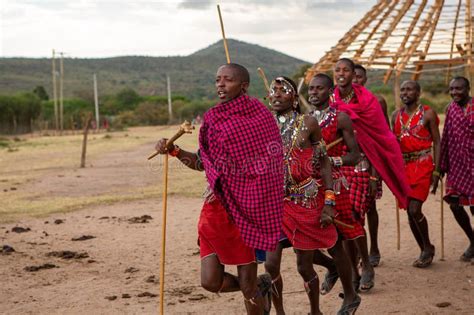 Masai In Traditional Colorful Clothing Showing Maasai Jumping Dance At