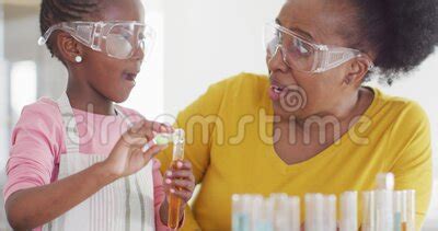 Excited African American Granddaughter And Grandmother Doing Chemistry