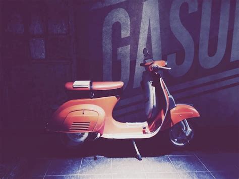 Premium Photo Book On Orange Motor Scooter Parked Against Wall