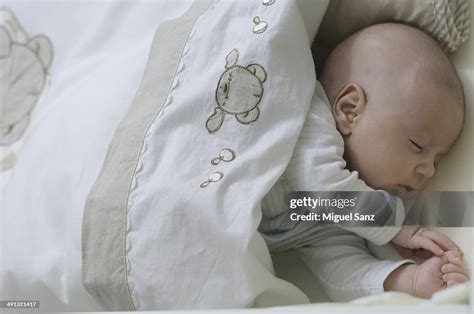 Newborn Sleeping In The Crib High-Res Stock Photo - Getty Images