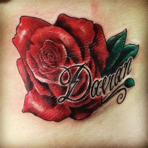 I wanted a rose with my sons name... My tattoo artist nailed it!! | Rose tattoo with name ...