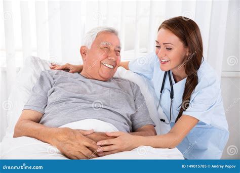 Nurse Looking At Happy Male Patient In Clinic Stock Image Image Of Home Caretaker 149015785