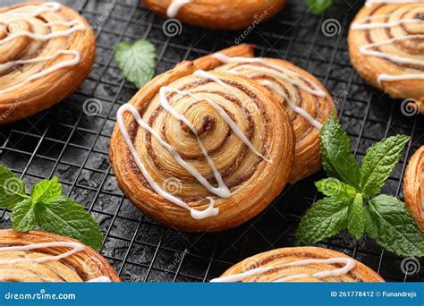 Freshly Baked Sweet Cinnamon Swirls With Icing On Cooling Rack Sweet