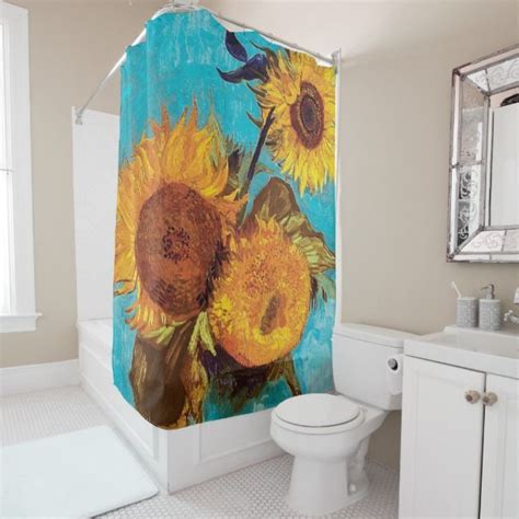 A Shower Curtain With Sunflowers Painted On It In A White And Blue Bathroom