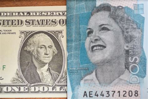 Premium Photo | Comparison of dollar bill with colombian peso concept ...