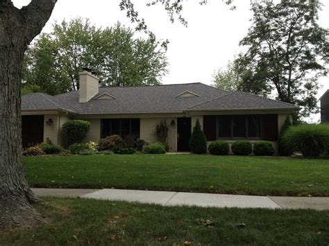 A House With Trees And Grass In The Front Yard