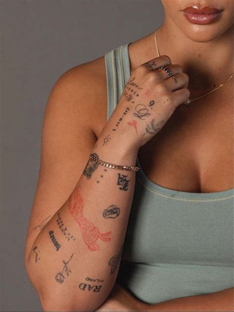 A Woman With Many Tattoos On Her Arm