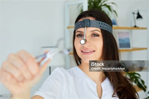 female medicine doctor examining patient  nasal mirror