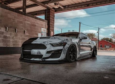 White Car Parked in Front of a Brick Building