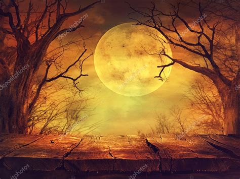 Spooky forest with full moon and wooden table Stock Photo by ©mythja ...