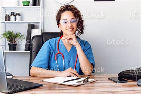 Hispanic Doctor Woman With Eyesight On Clinic Office Looking At Camera