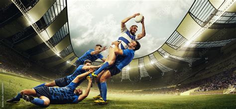 Professional sport. Men, rugby players during game, catching ball at 3D open air stadium ...