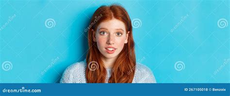 Headshot Of Cute Redhead Girl With Freckles Looking Hopeful And