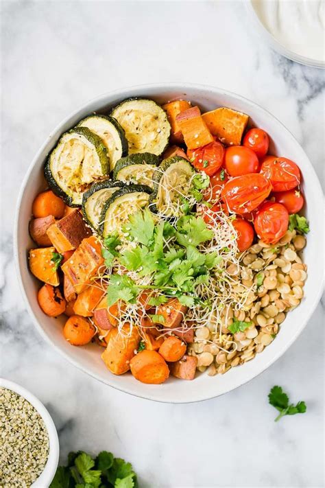 Roasted Vegetables And Lentil Nourish Bowl On A Marble Table With Text