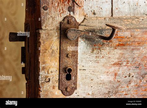 Old Rough Wooden Door And Close Up Of Rusty Iron Lock And Handle Stock