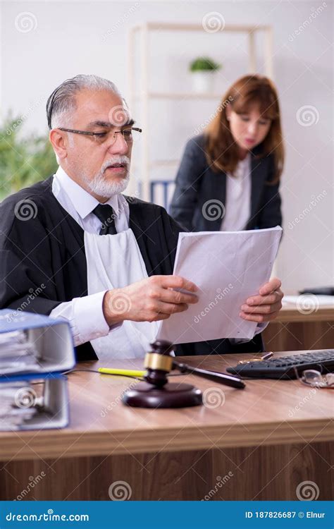 Old Male Judge And His Young Secretary In The Office Stock Image