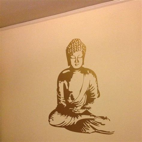 A Wall With A Buddha Statue On It In A Room That Is Painted White And Brown