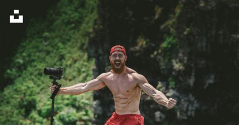 Standing Man Wearing Red Shorts And Holding Black Camera Photo Free Film Image On Unsplash